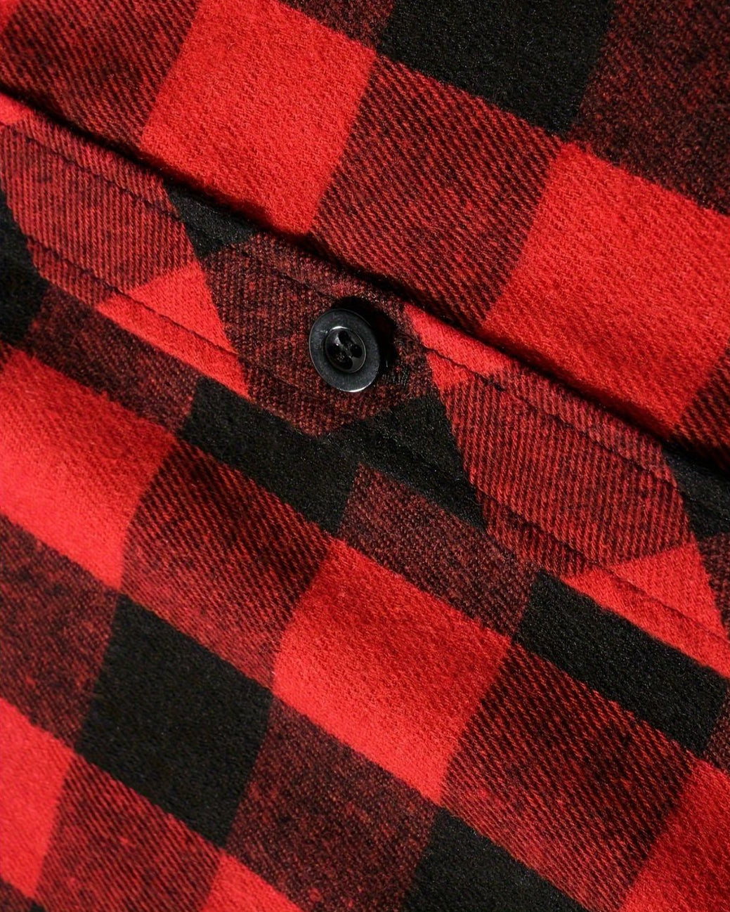 Close-up of a red and black plaid brushed flannel shirt featuring a button-down chest pocket.