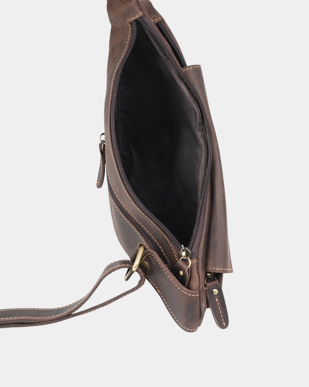 Open brown vintage leather crossbody sling bag with a secure zip closure, adjustable strap, and compact vertical design.