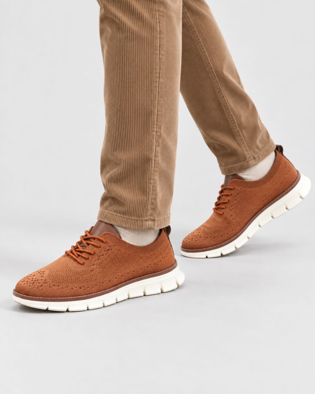 Men’s brown breathable mesh dress sneakers with lace-up closure and a comfortable white cushioned EVA sole.