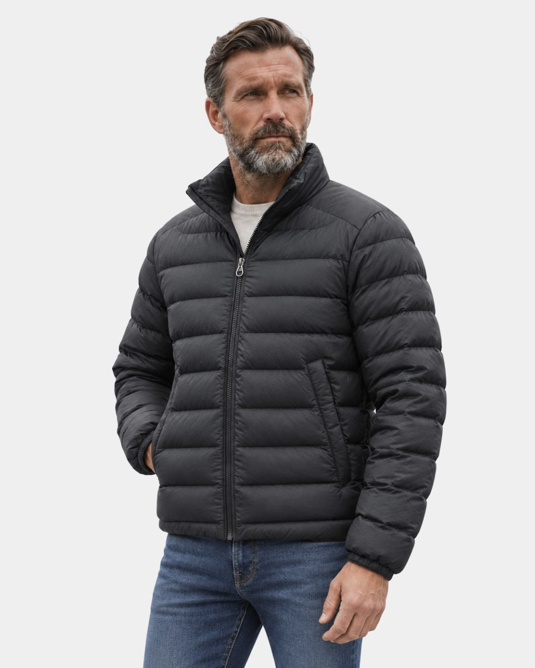 Man wearing a black lightweight quilted duck down puffer jacket with a stand collar and full-zip front.