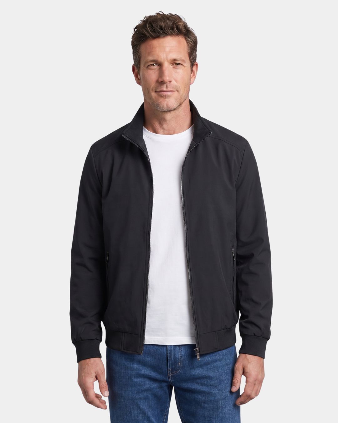 Man wearing a black lightweight Harrington jacket with a stand collar, zip front, and ribbed cuffs over a white T-shirt.