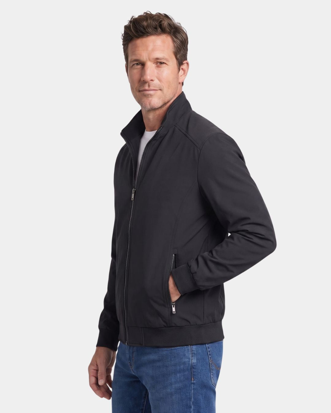 Man wearing a black lightweight Harrington jacket with a stand collar, zip front, and ribbed cuffs.