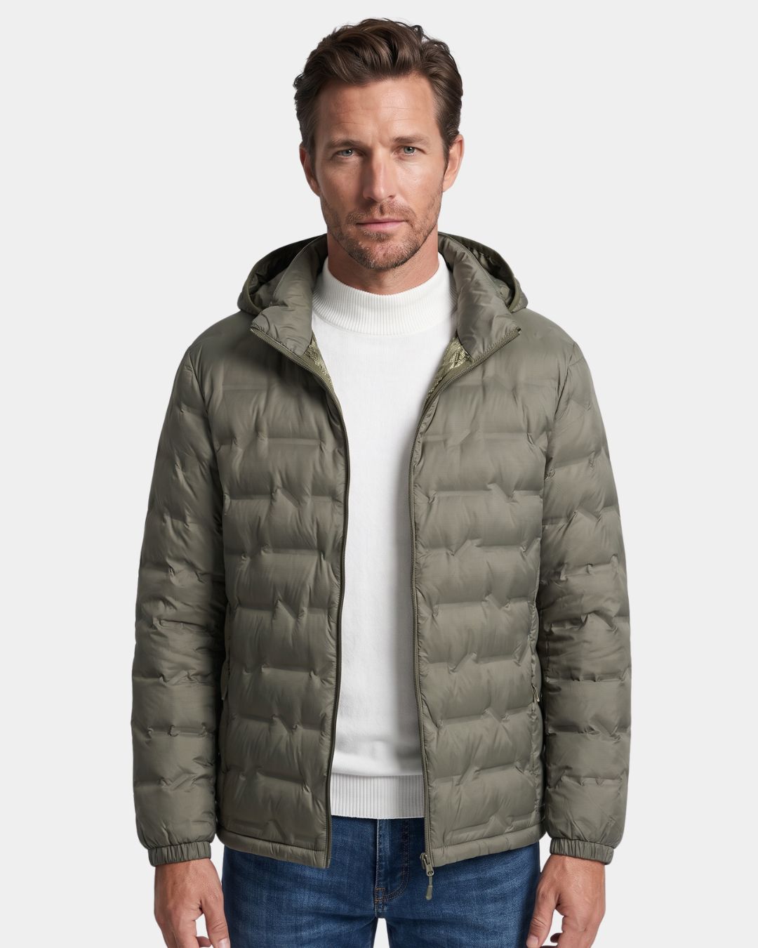 Man wearing an olive green lightweight quilted down puffer jacket with a detachable hood and full-zip front.