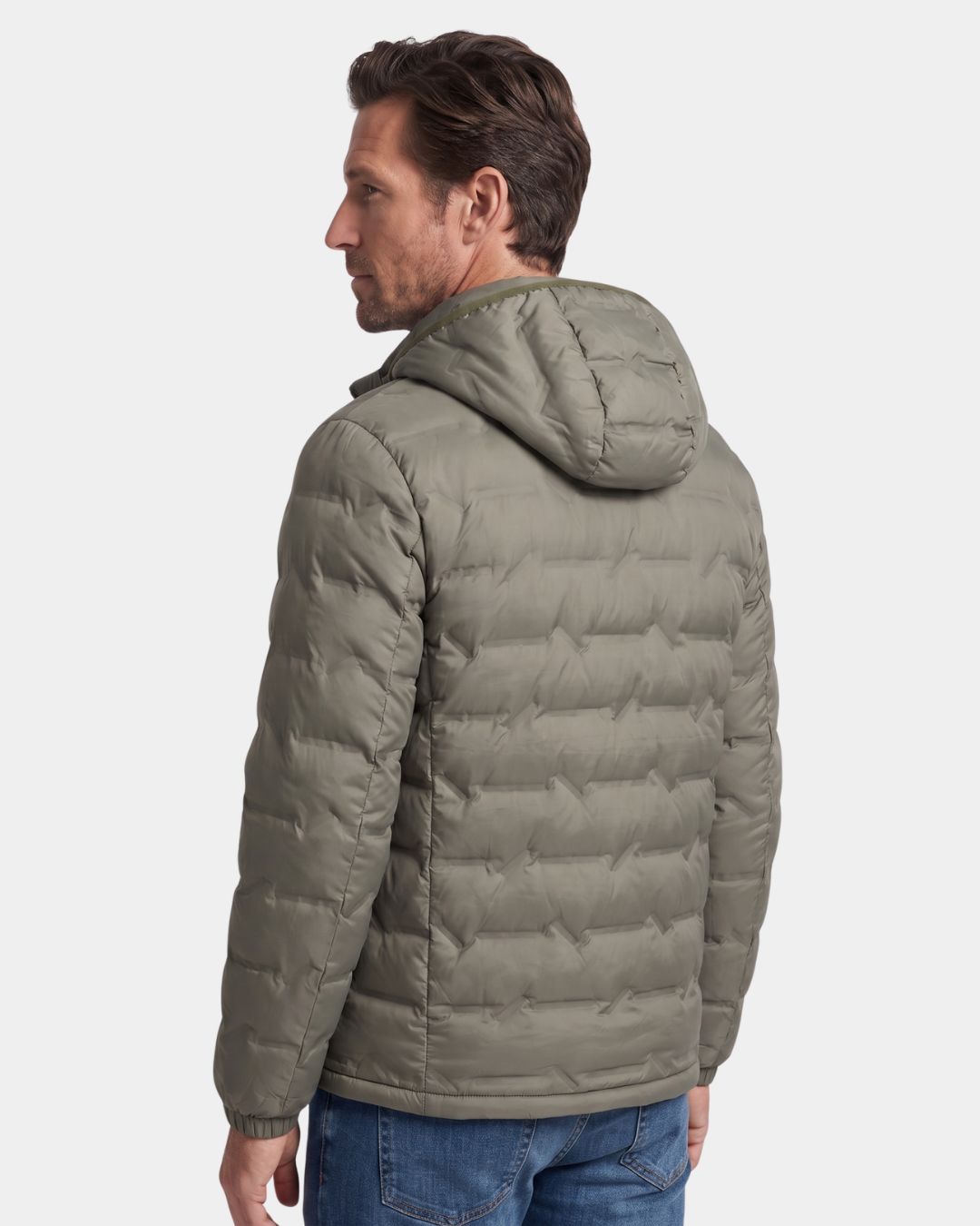 Man wearing a sage green lightweight quilted down puffer jacket with a detachable hood and zip-up design.
