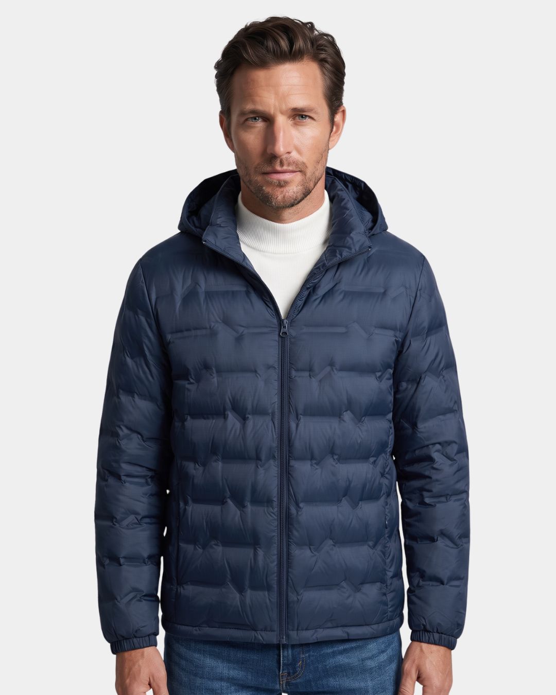 Man wearing a navy blue lightweight quilted down puffer jacket with a detachable hood and full-zip front.