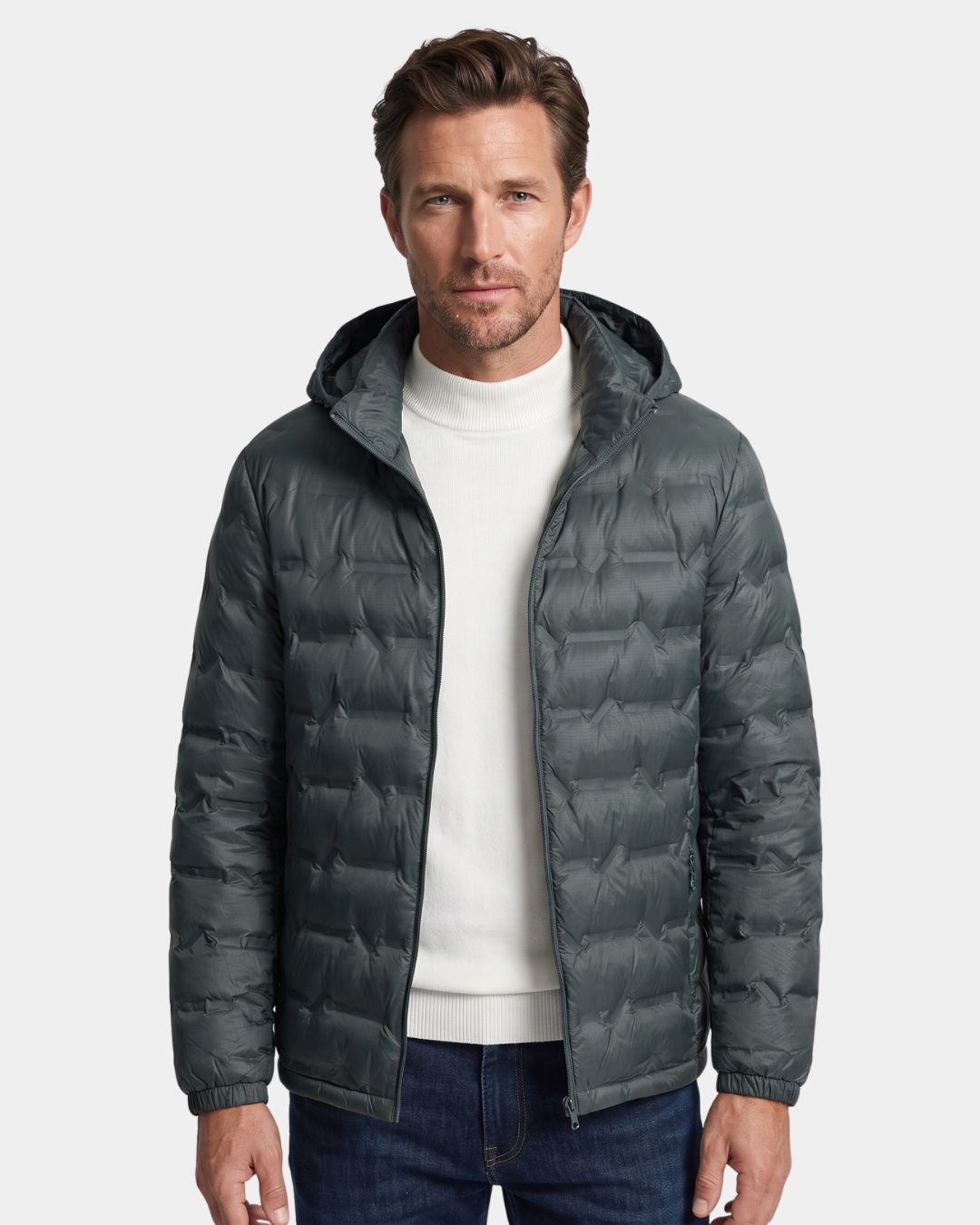 Man wearing a dark grey lightweight quilted down puffer jacket with a detachable hood and full-zip front.