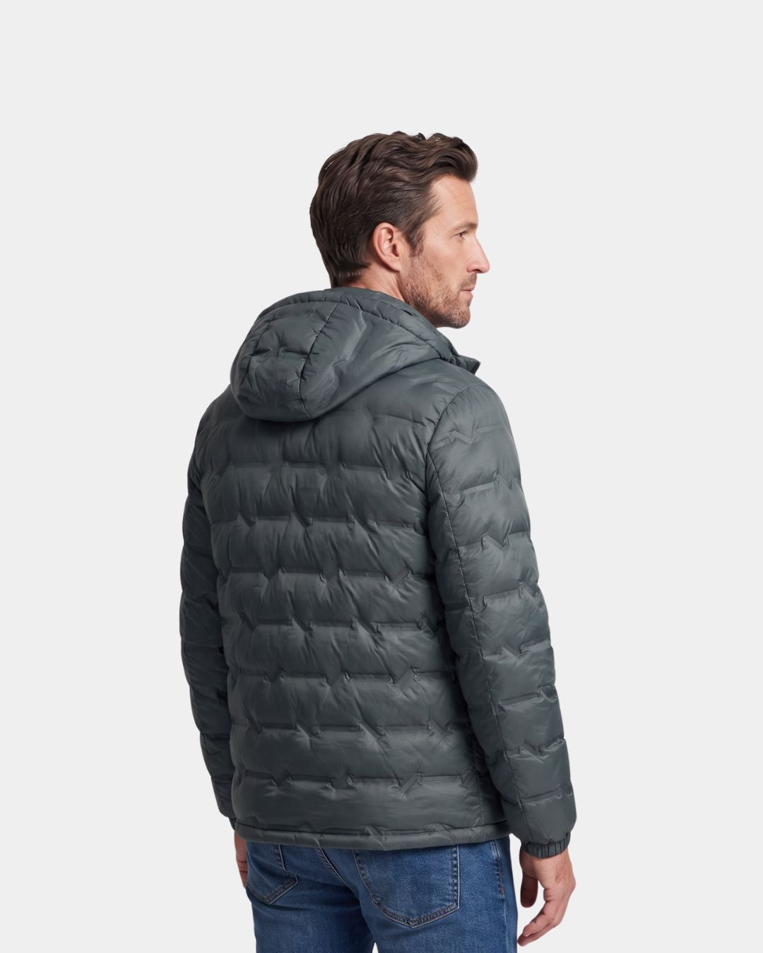 Man wearing a dark grey, lightweight quilted down puffer jacket with a detachable hood and zip-up design.