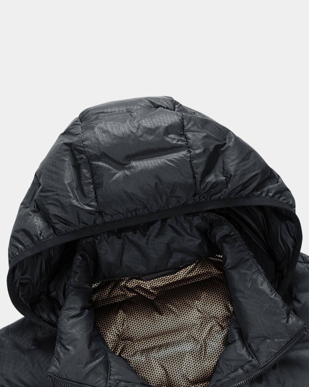 Black quilted puffer jacket hood with a waterproof grid pattern and a gold honeycomb-textured interior lining.