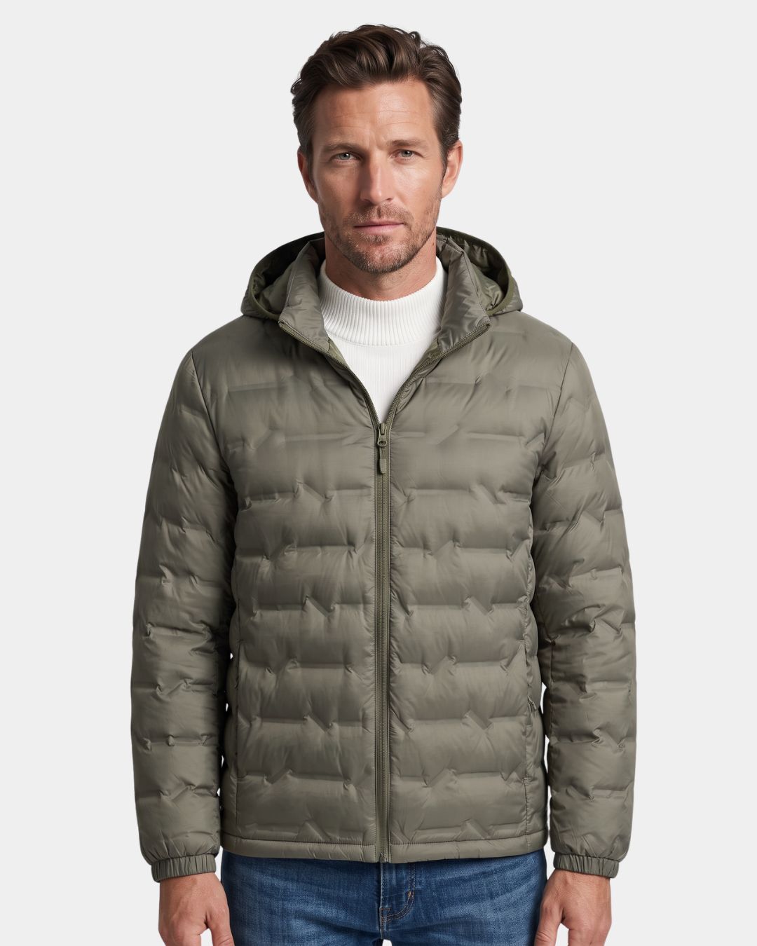Man wearing a sage green lightweight quilted down puffer jacket with a detachable hood and full-zip front.