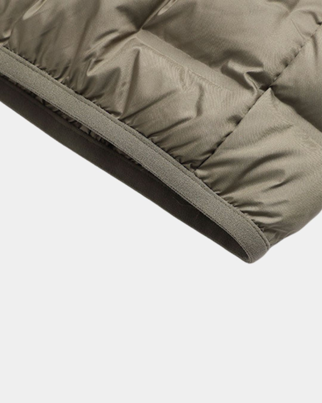 Close-up of a taupe men’s lightweight down puffer jacket featuring quilted construction and an elasticated cuff.