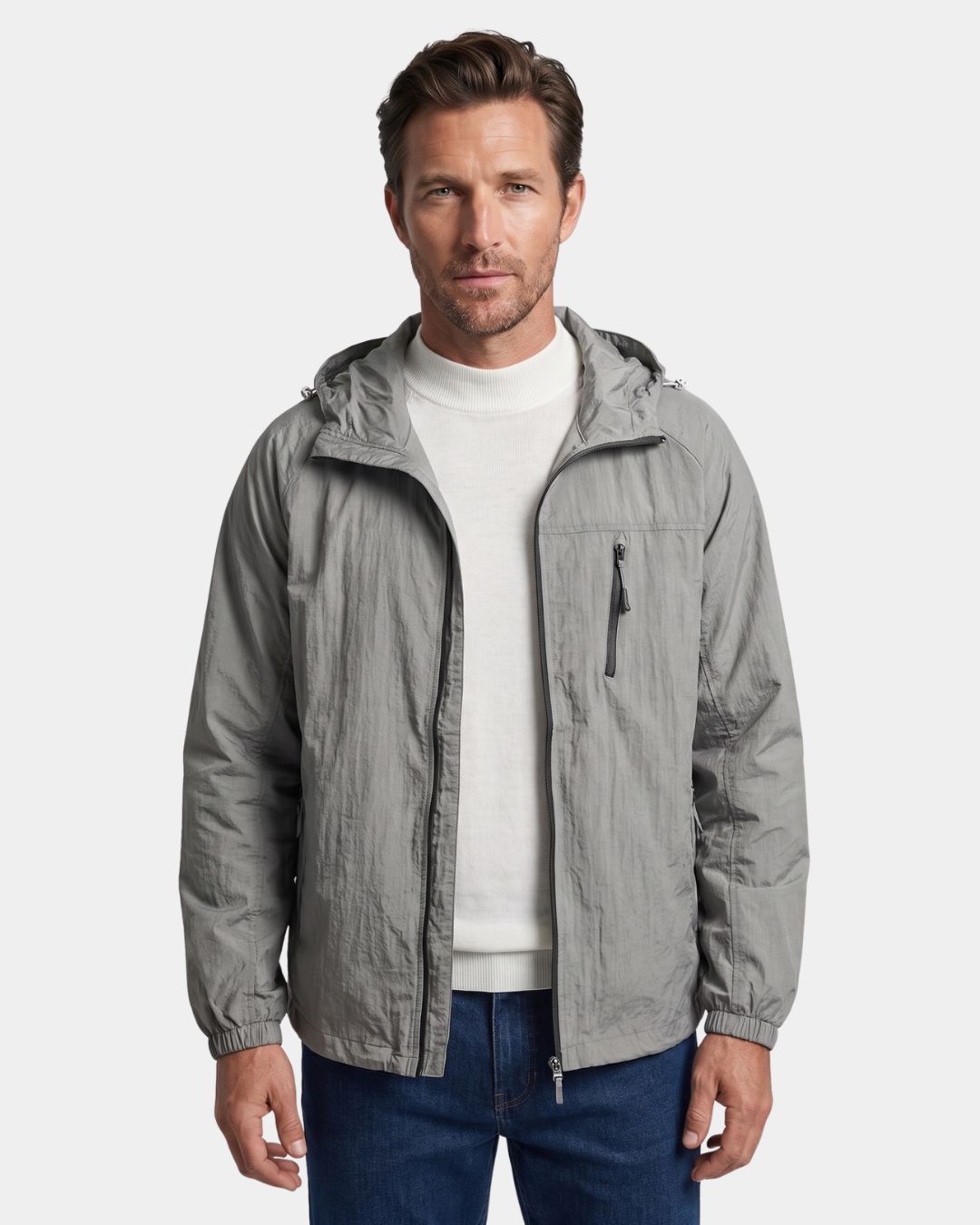 Man wearing a grey lightweight waterproof windbreaker jacket with a hood, full-zip front, and zippered chest pocket.