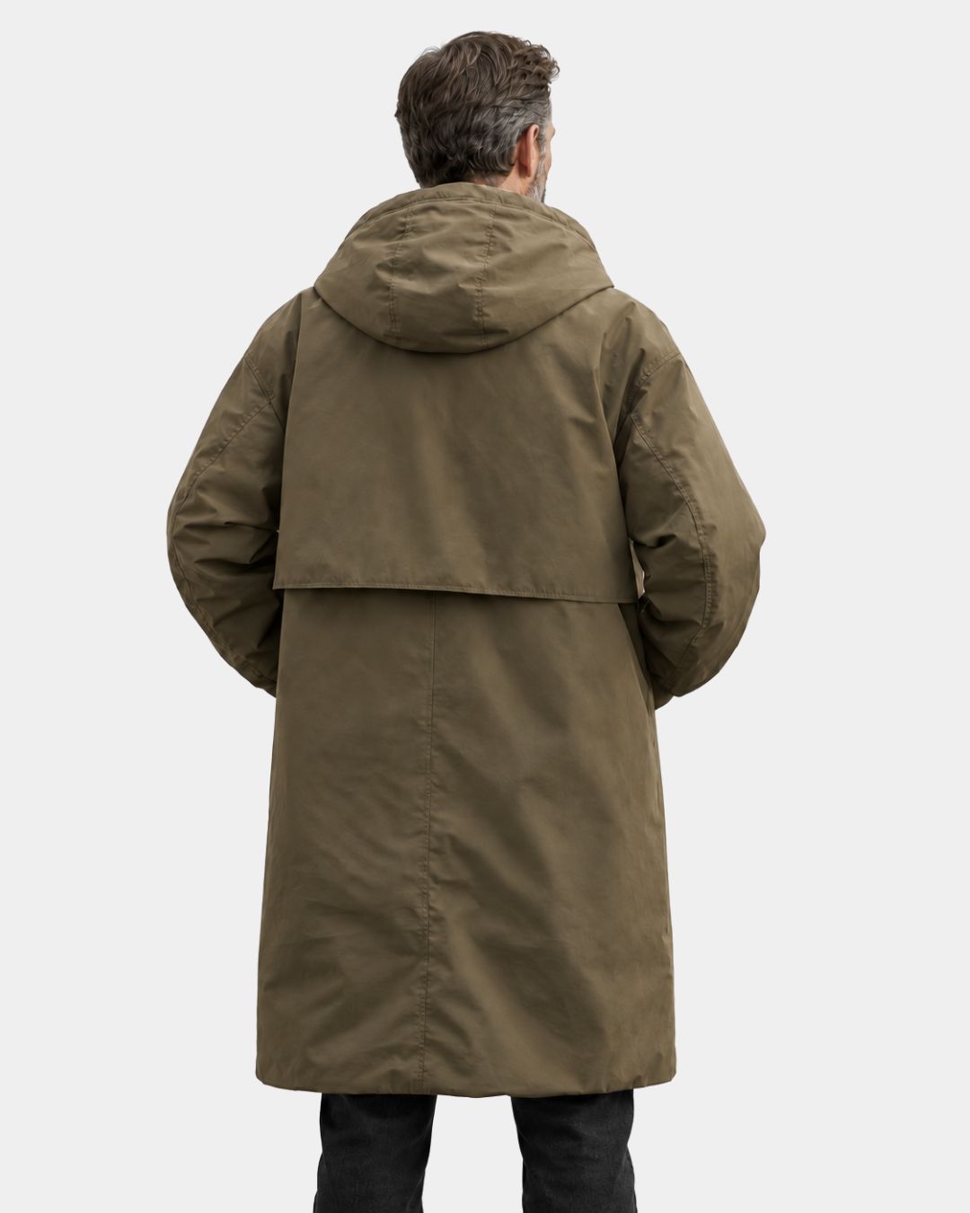 Man wearing a long, olive green hooded overcoat with a relaxed fit and trench-inspired back yoke design.