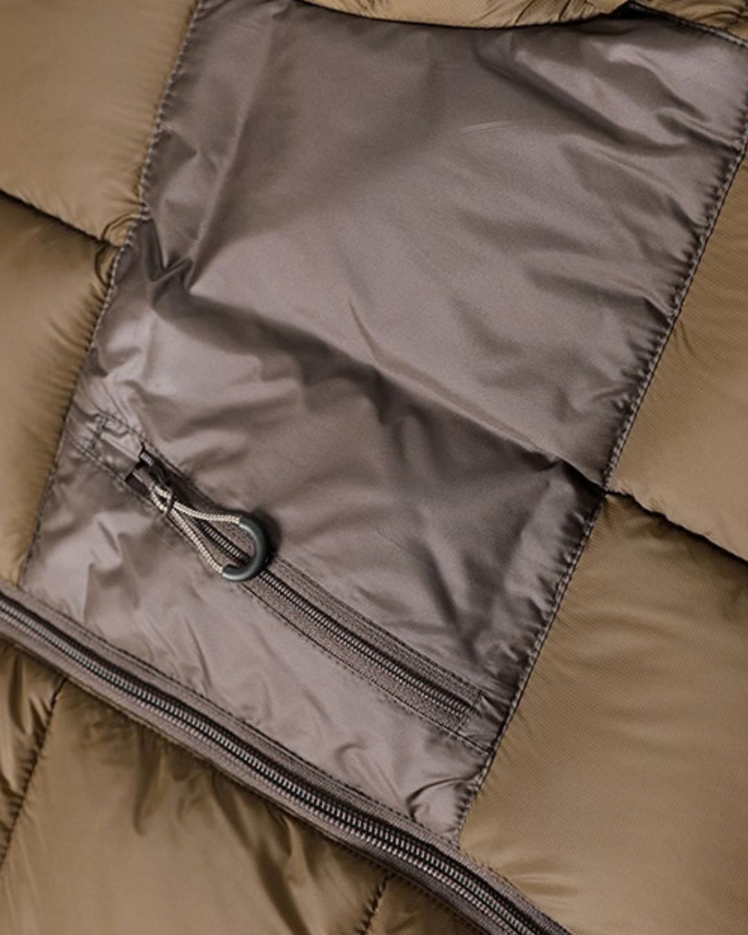 Olive green padded puffer jacket featuring a smooth contrast chest panel and a secure zippered pocket.