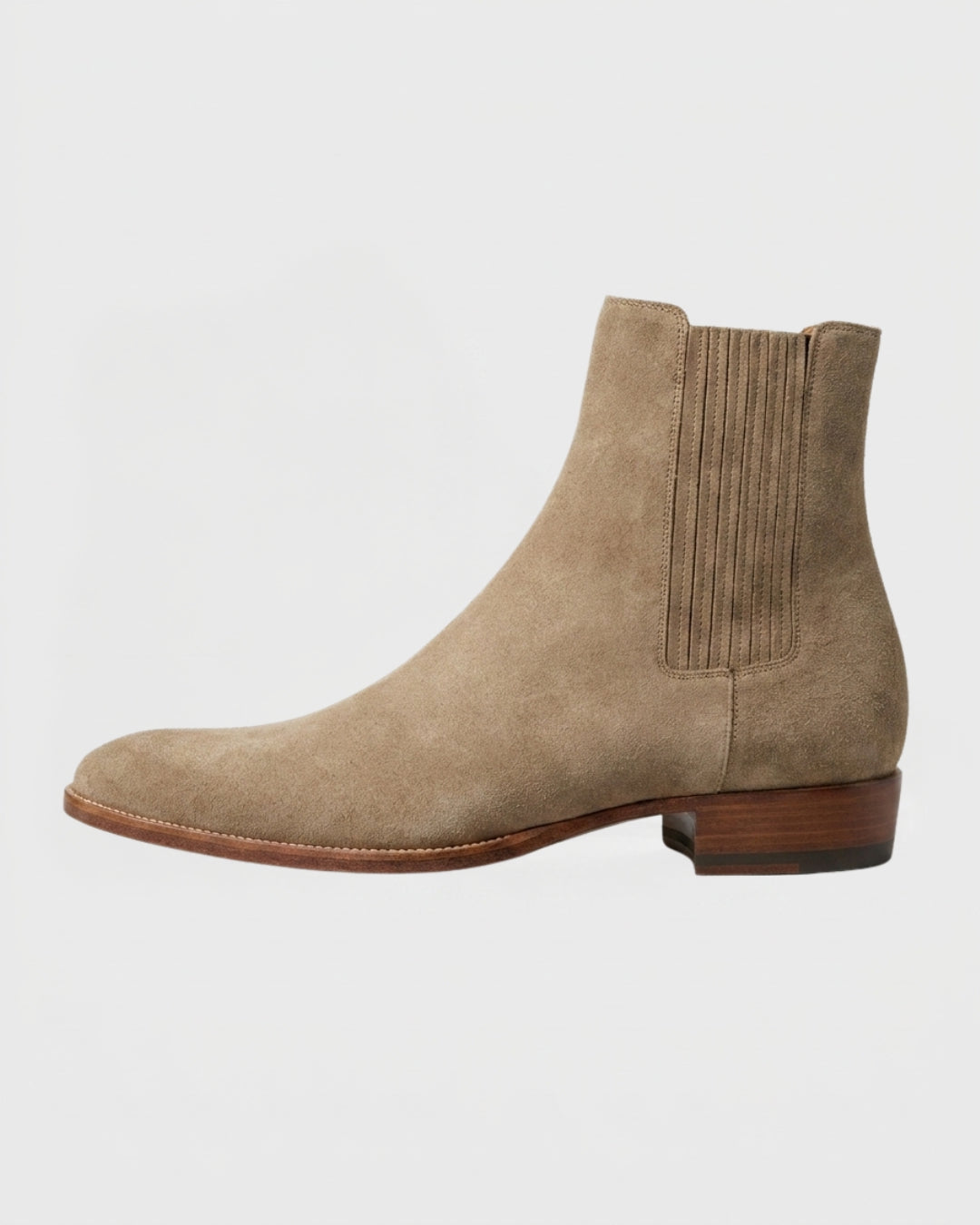 Men’s beige suede Chelsea boots with a pointed toe, elastic side panels, and a low stacked heel on a white background.