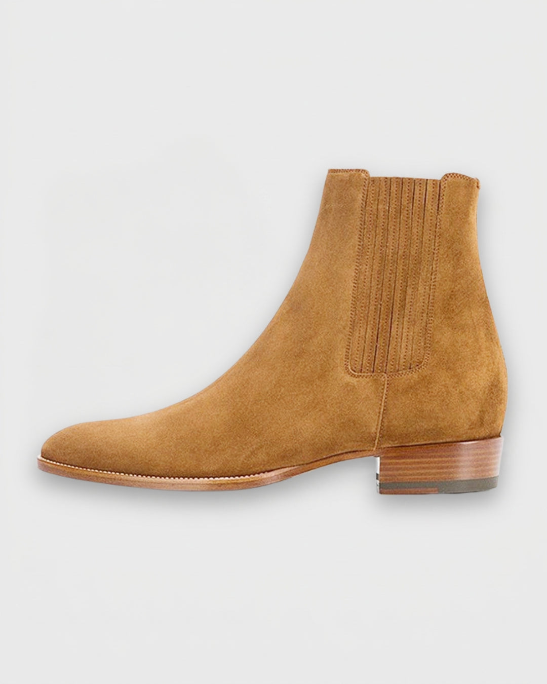 Cognac suede men’s Chelsea boots with a pointed toe, elastic side panels, and a low stacked heel on a white background.