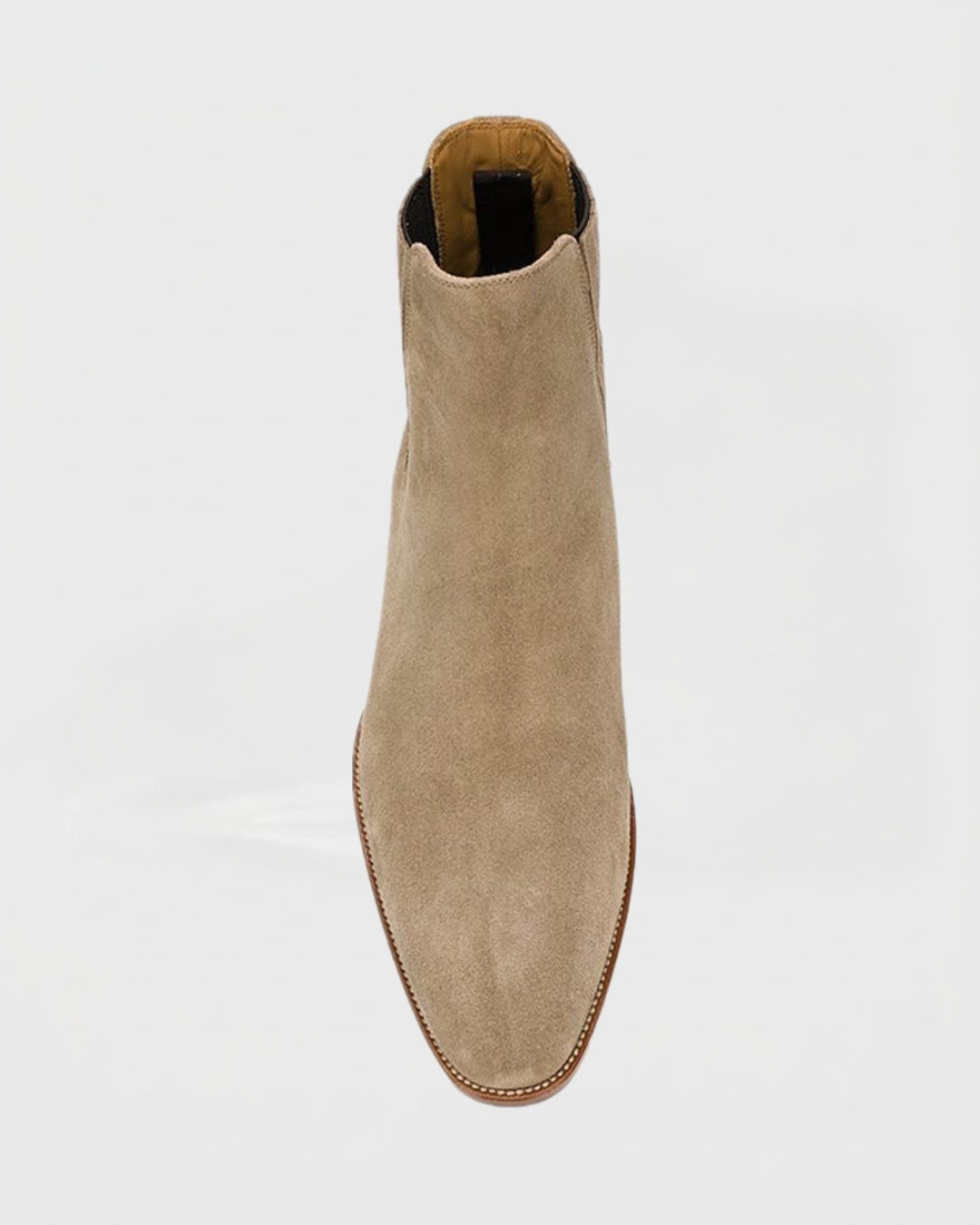 Men’s beige suede Chelsea boots with a pointed toe, elastic side panels, and a slim profile on a white background.