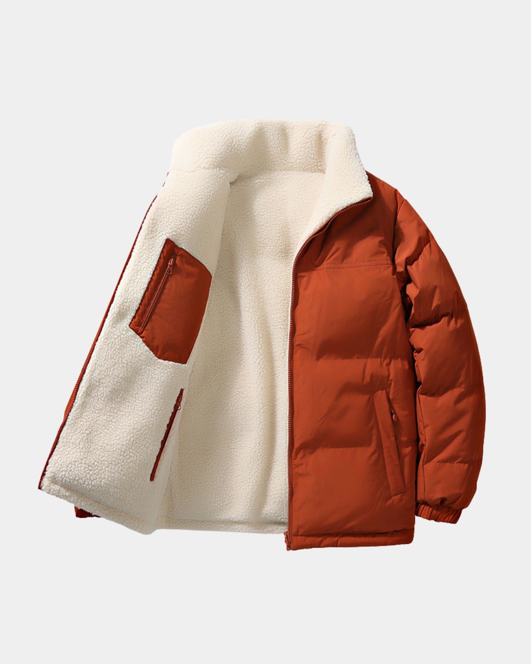 Rust orange reversible puffer jacket with a cream fleece interior, stand collar, and full-zip front.