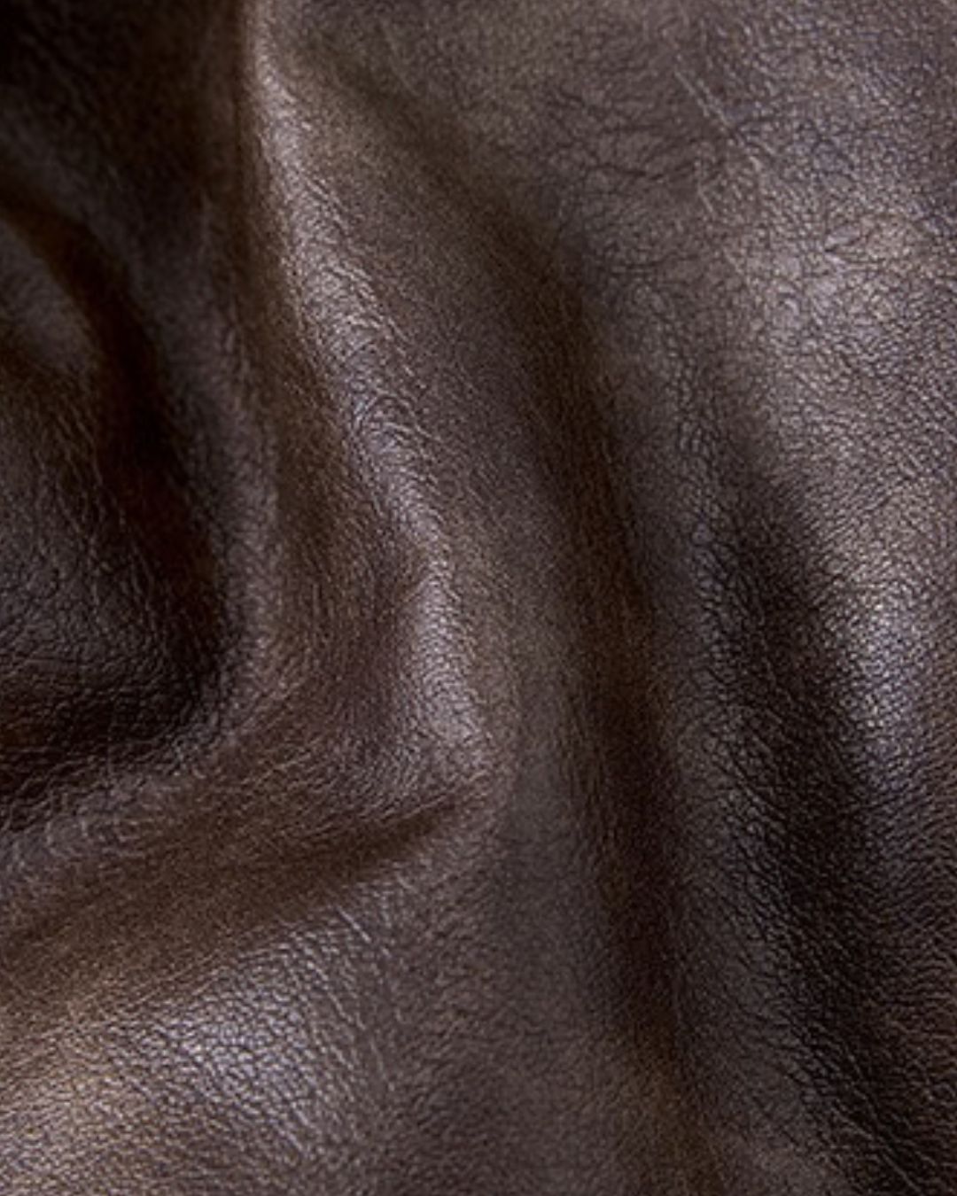 Close-up of the smooth, dark brown waterproof outer material of a reversible men’s trapper hat.