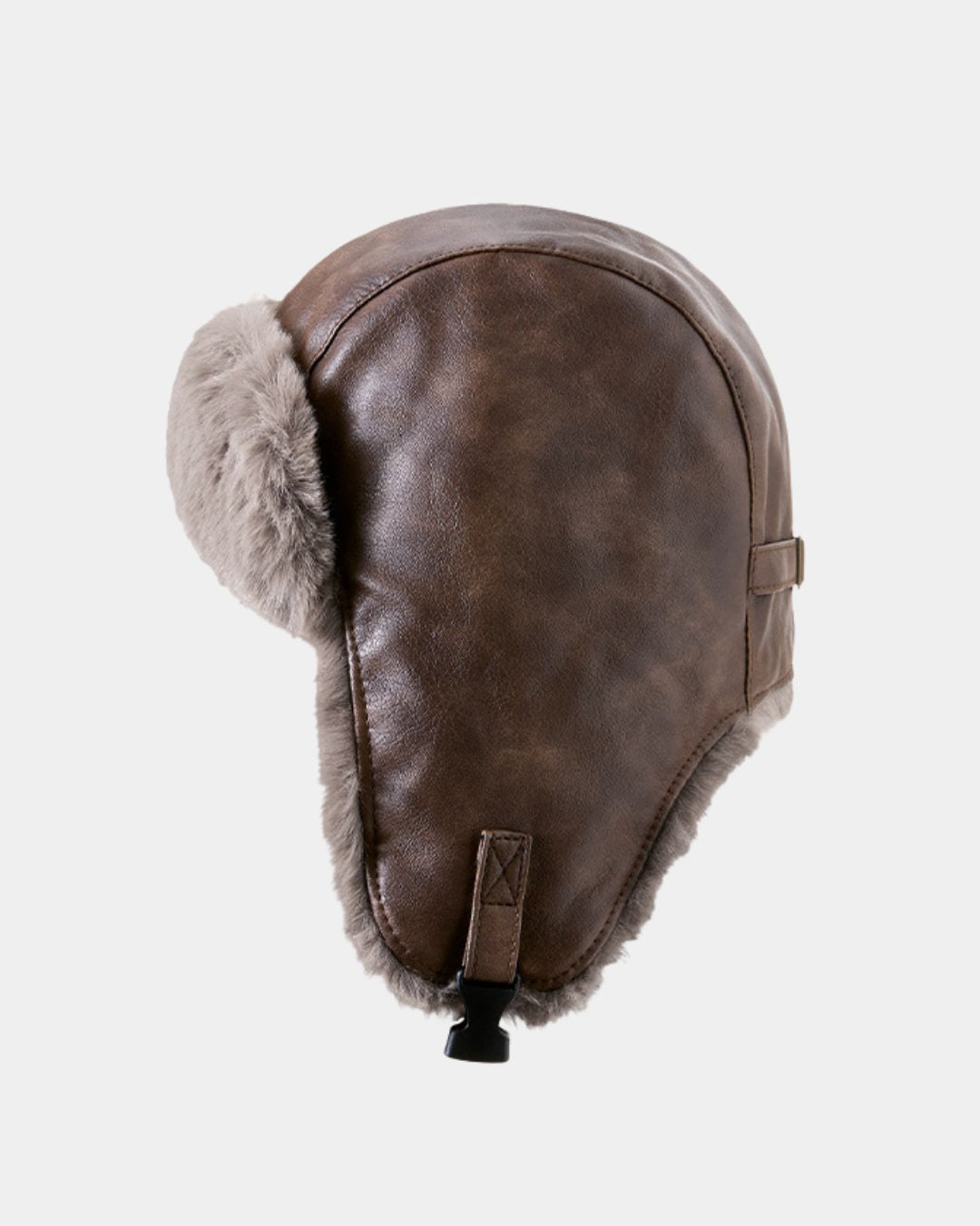 Brown faux leather reversible trapper hat with soft grey fleece lining, ear flaps, and an adjustable chin buckle.