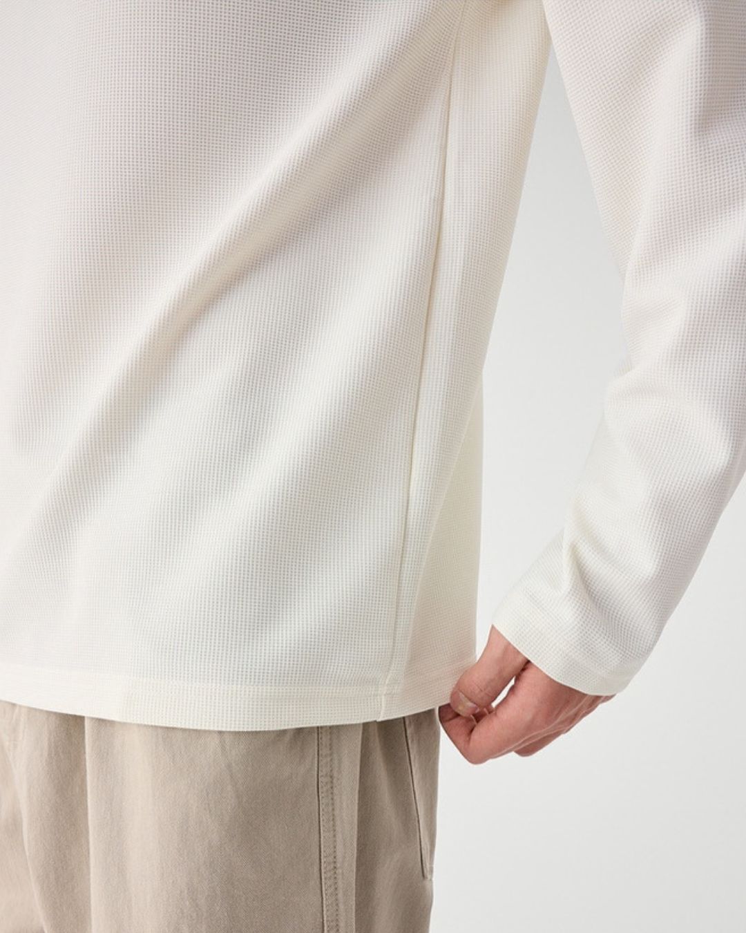 Off-white long sleeve henley shirt in a soft, textured waffle knit fabric with a relaxed fit.
