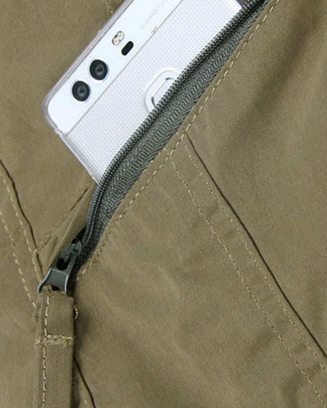Olive green fleece-lined cargo pants featuring a secure zippered side pocket holding a smartphone.