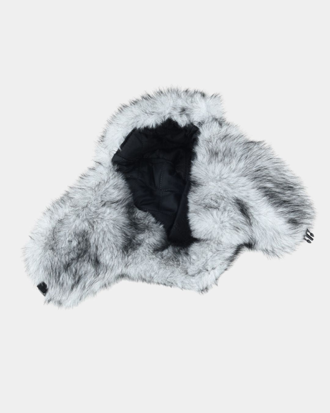 Men's winter ushanka trapper hat in grey and white faux fur with a black quilted interior and protective ear flaps.
