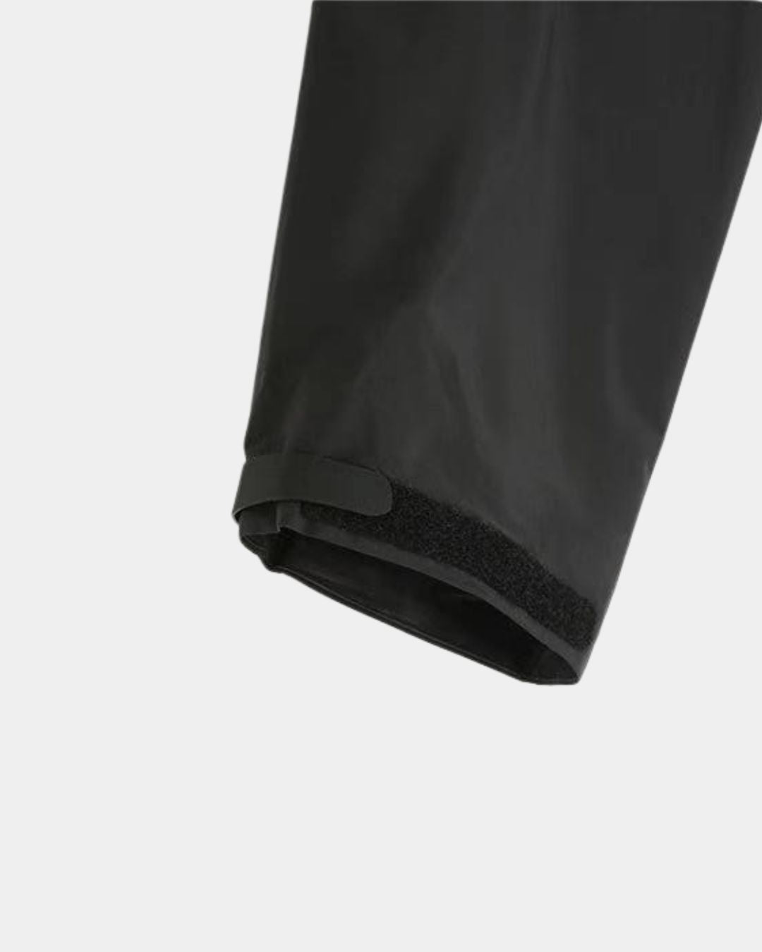 Close-up of a black waterproof hiking jacket sleeve with an adjustable Velcro cuff for a secure fit.