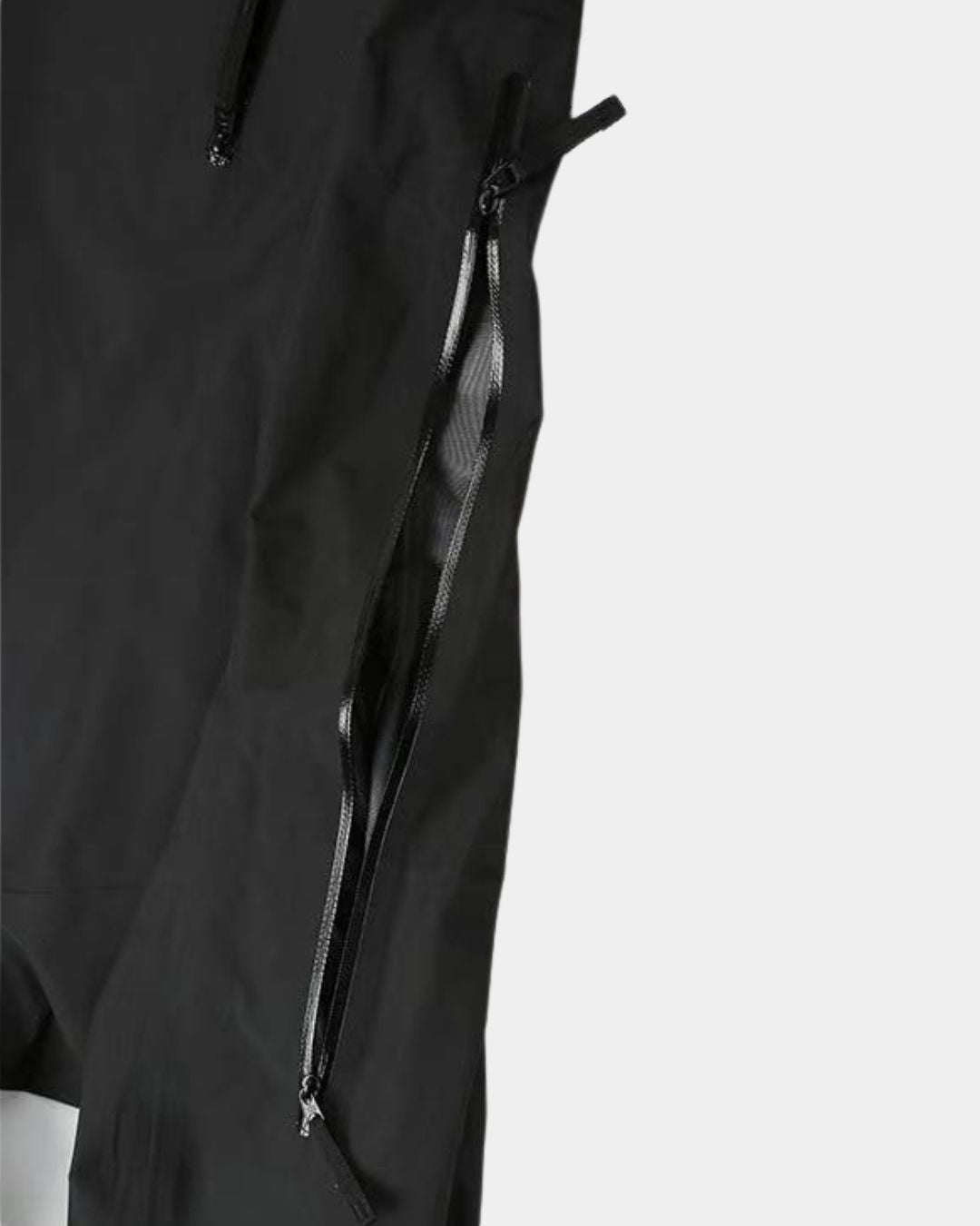 Close-up of a black waterproof hiking jacket featuring a water-resistant underarm ventilation zipper.