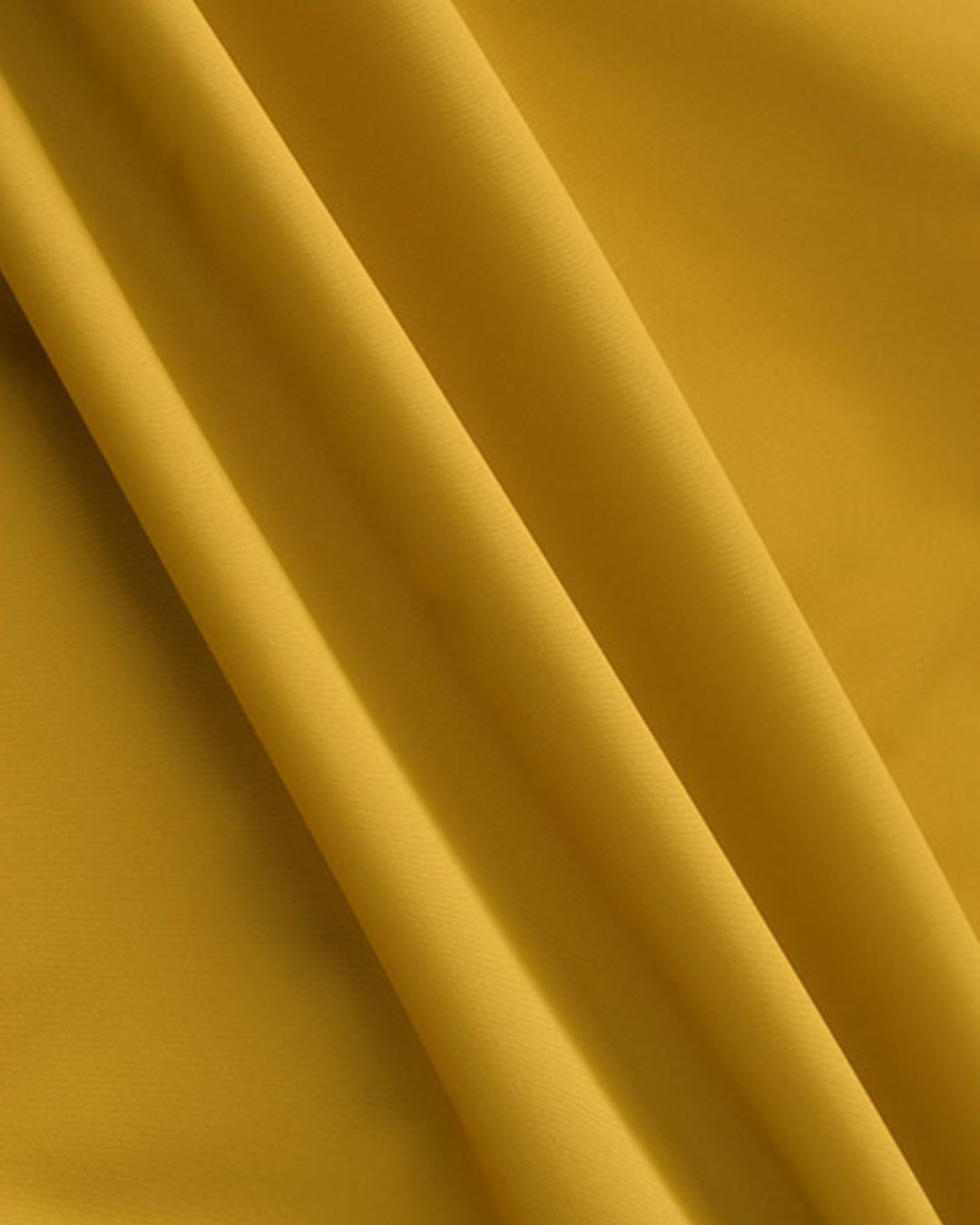 Close-up of yellow windbreaker jacket fabric showing smooth weather-resistant texture