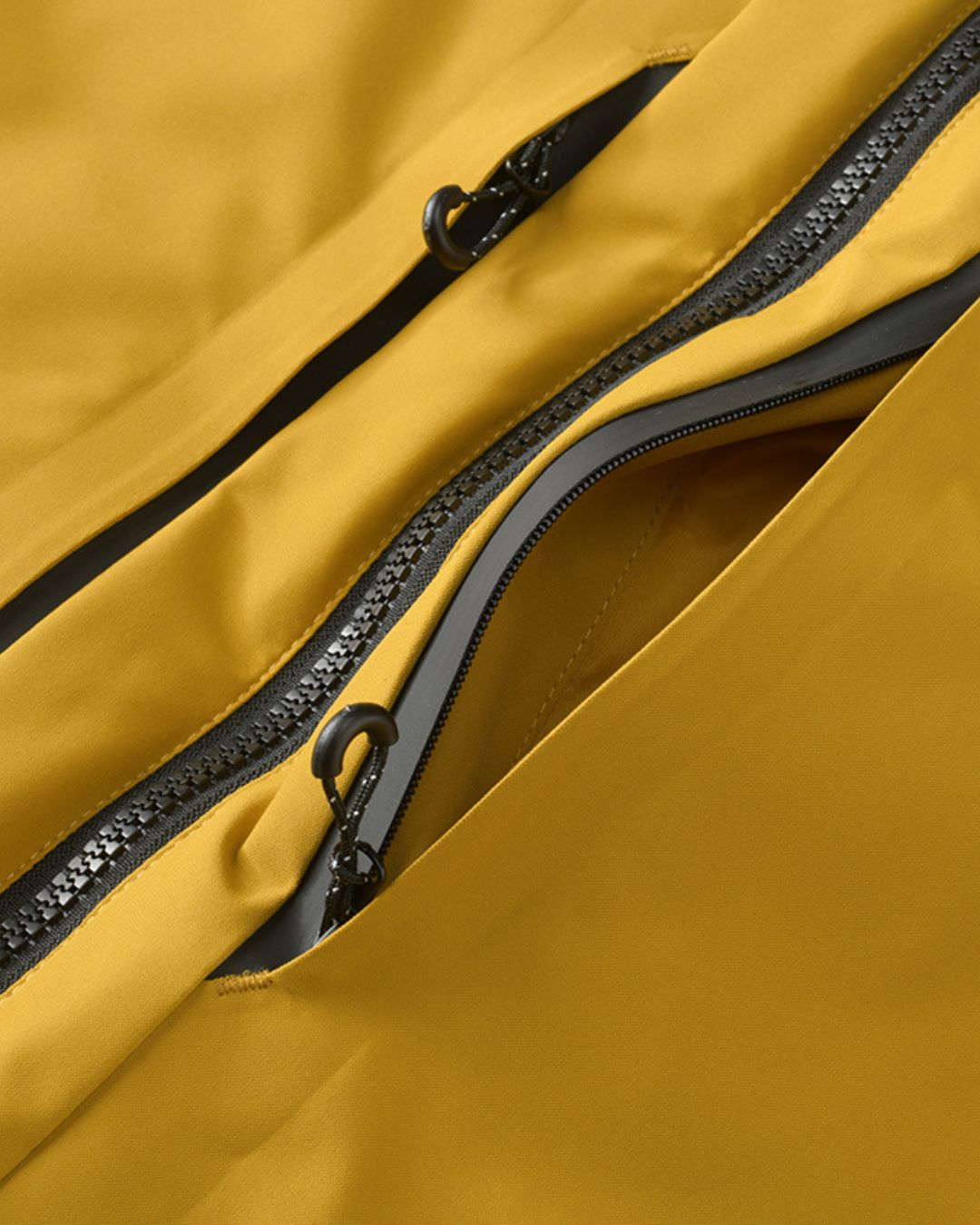 Close-up of men's yellow waterproof windbreaker jacket with zippered chest pocket