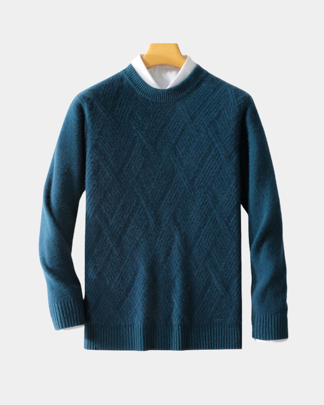 Blue wool crewneck sweater with a raised diamond knit pattern, ribbed trim, and a white collared shirt layered underneath.