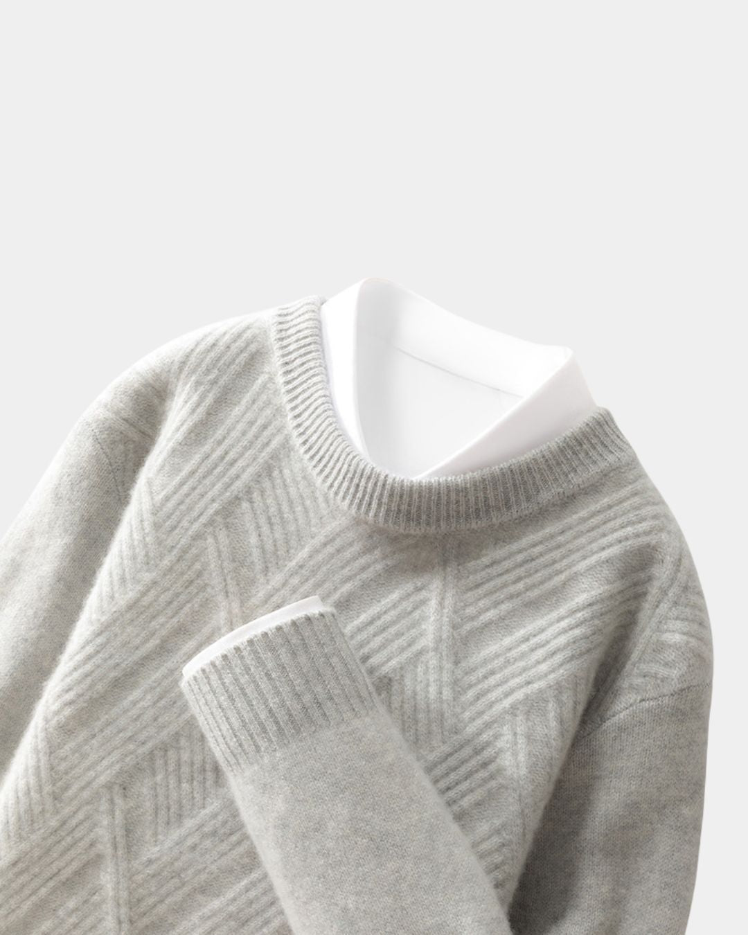 Grey wool crewneck sweater with a raised diamond knit pattern, ribbed trim, and a white collared shirt layered underneath.