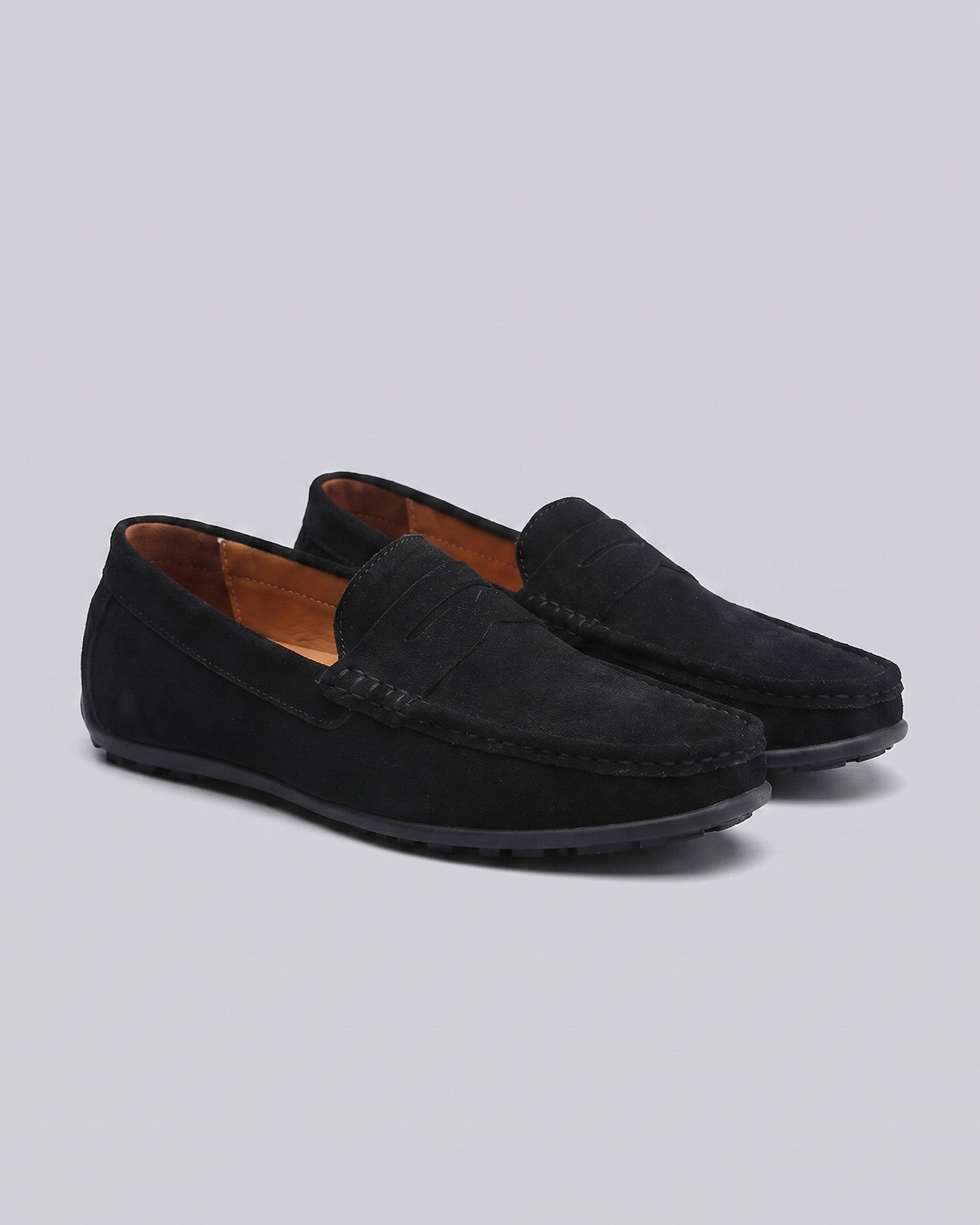 Pair of Nigel men's black suede driving loafers with tonal penny strap and flexible rubber sole
