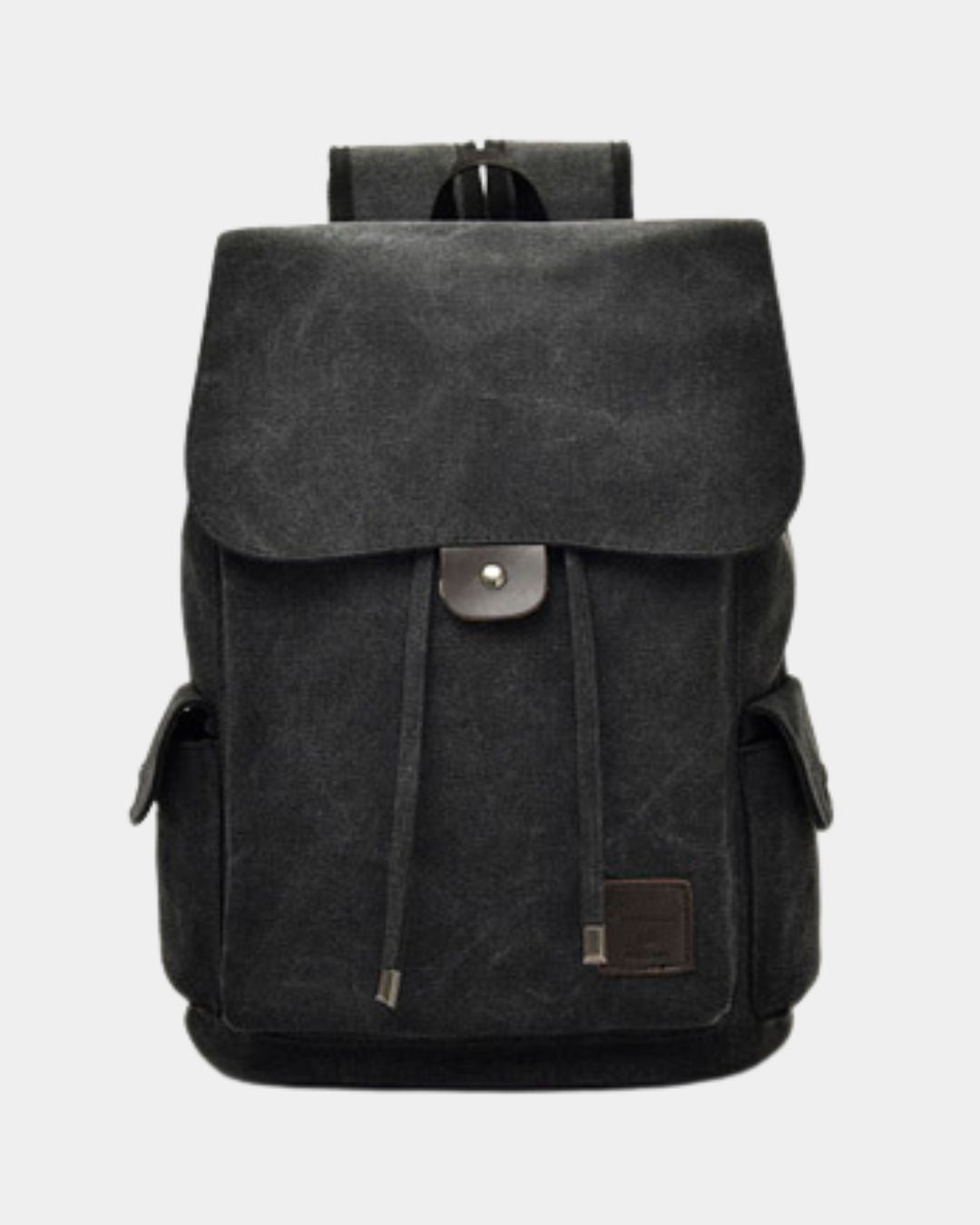 A black canvas backpack with a front flap, drawstring closure, and a small brown leather patch on the lower right, by Hudson & Tate.