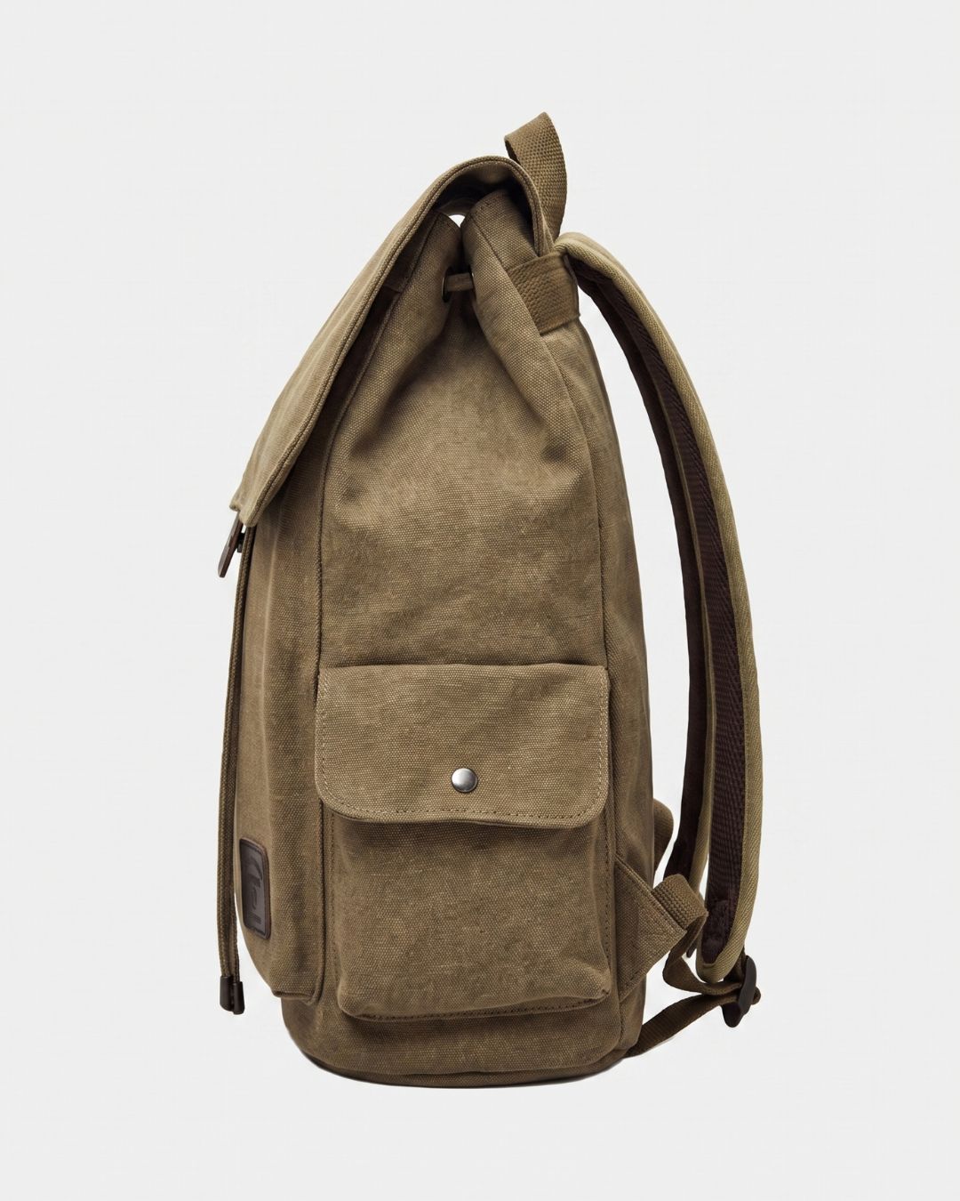 A khaki canvas backpack with a front flap pocket secured by a silver snap button, shown from a side profile view against a light gray background.