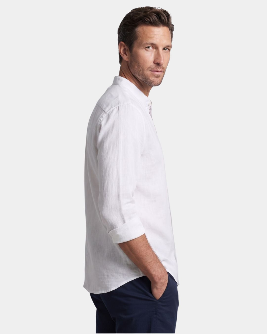 Man wearing a white linen-cotton blend long-sleeve shirt with a stand collar and button-down front.