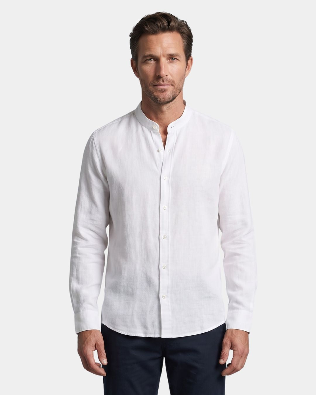 Man wearing a white long-sleeve linen-cotton blend shirt with a stand collar and button-down front.