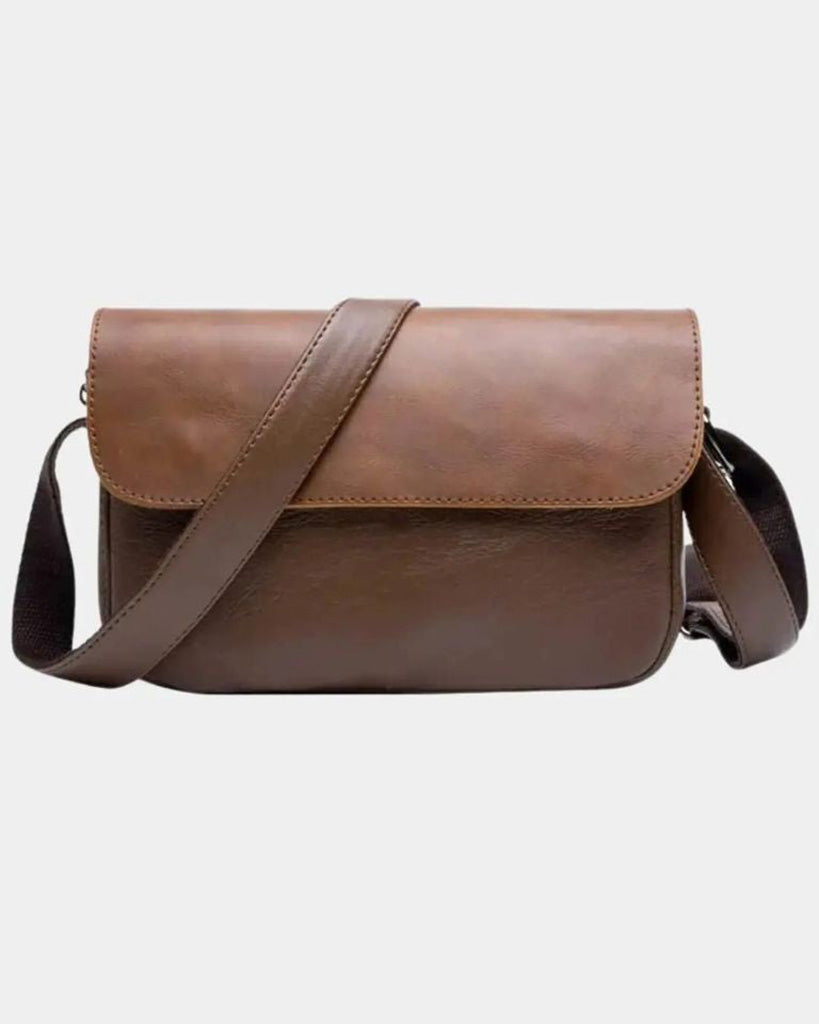 Front view of Torino men's brown crossbody bag with structured flap and adjustable shoulder strap