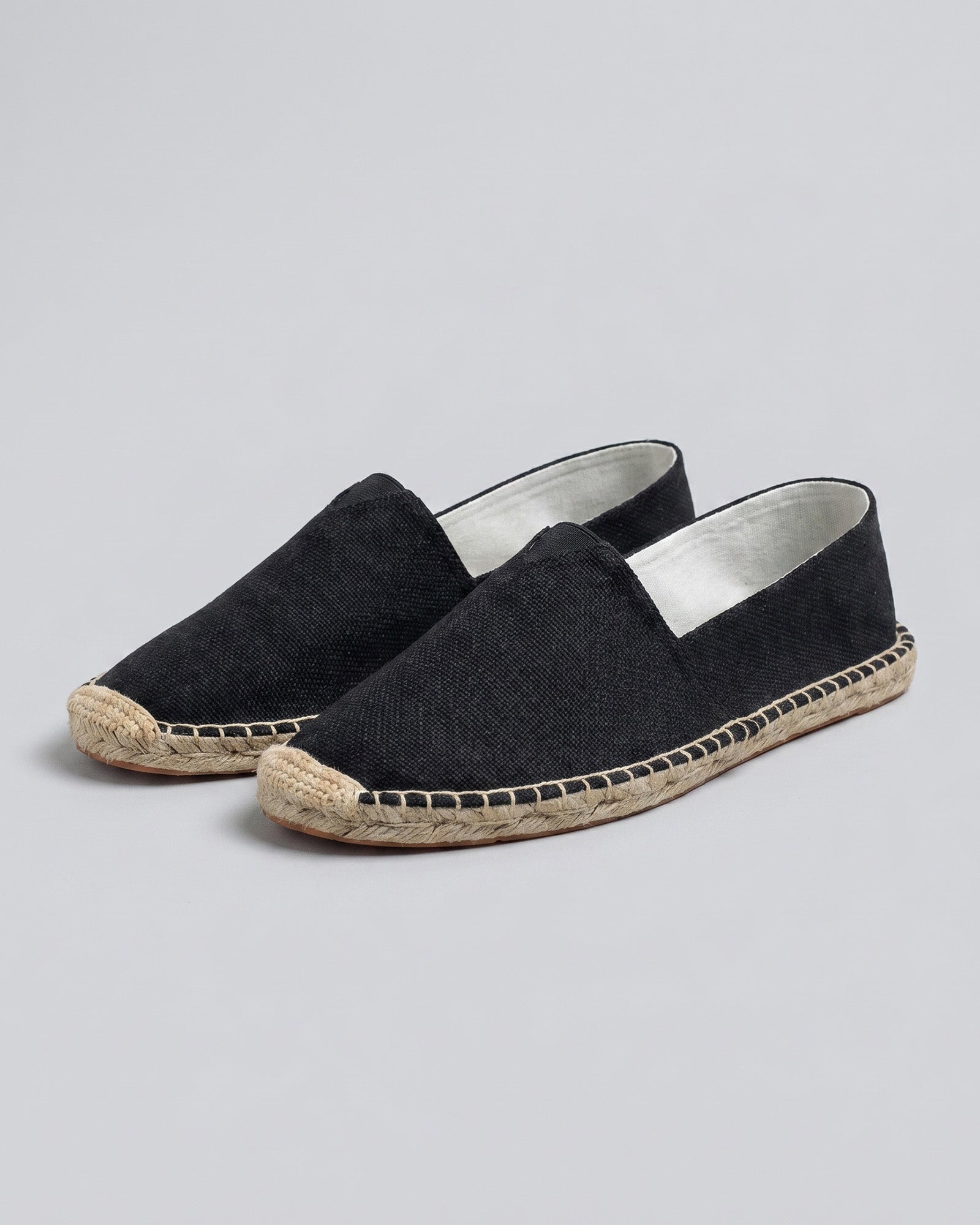 Pair of Tulum men's black canvas espadrille loafers with woven jute sole