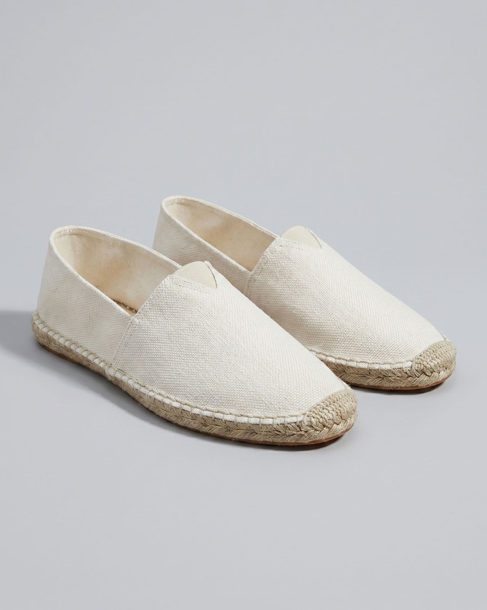 Pair of Tulum men's white canvas espadrille loafers with woven jute sole