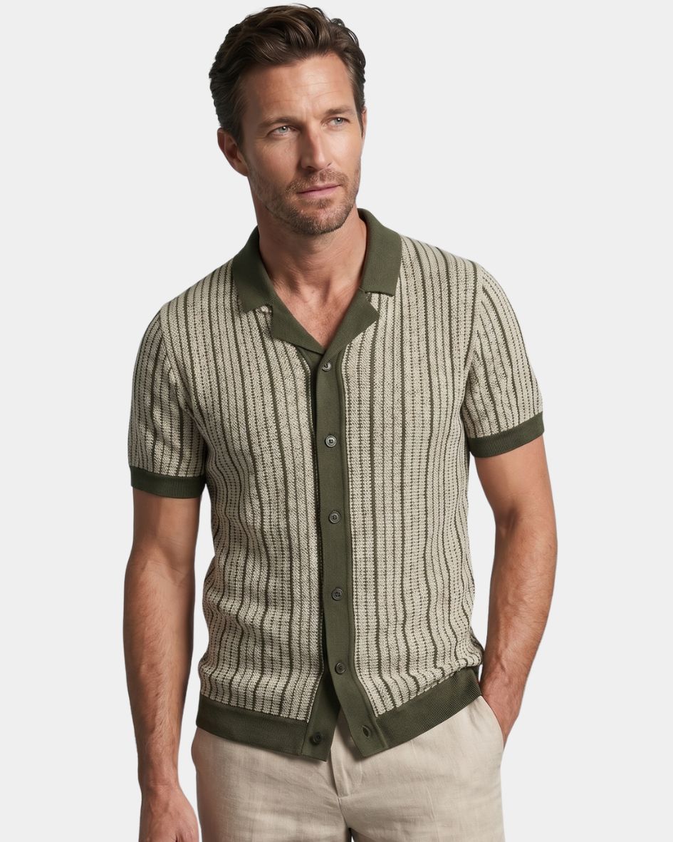 Man wearing a patterned shirt with green accents on a light gray background