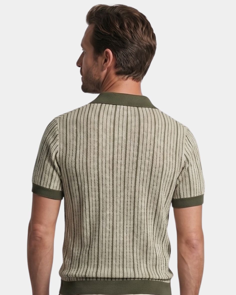 Man wearing a patterned polo shirt with green accents on a light gray background